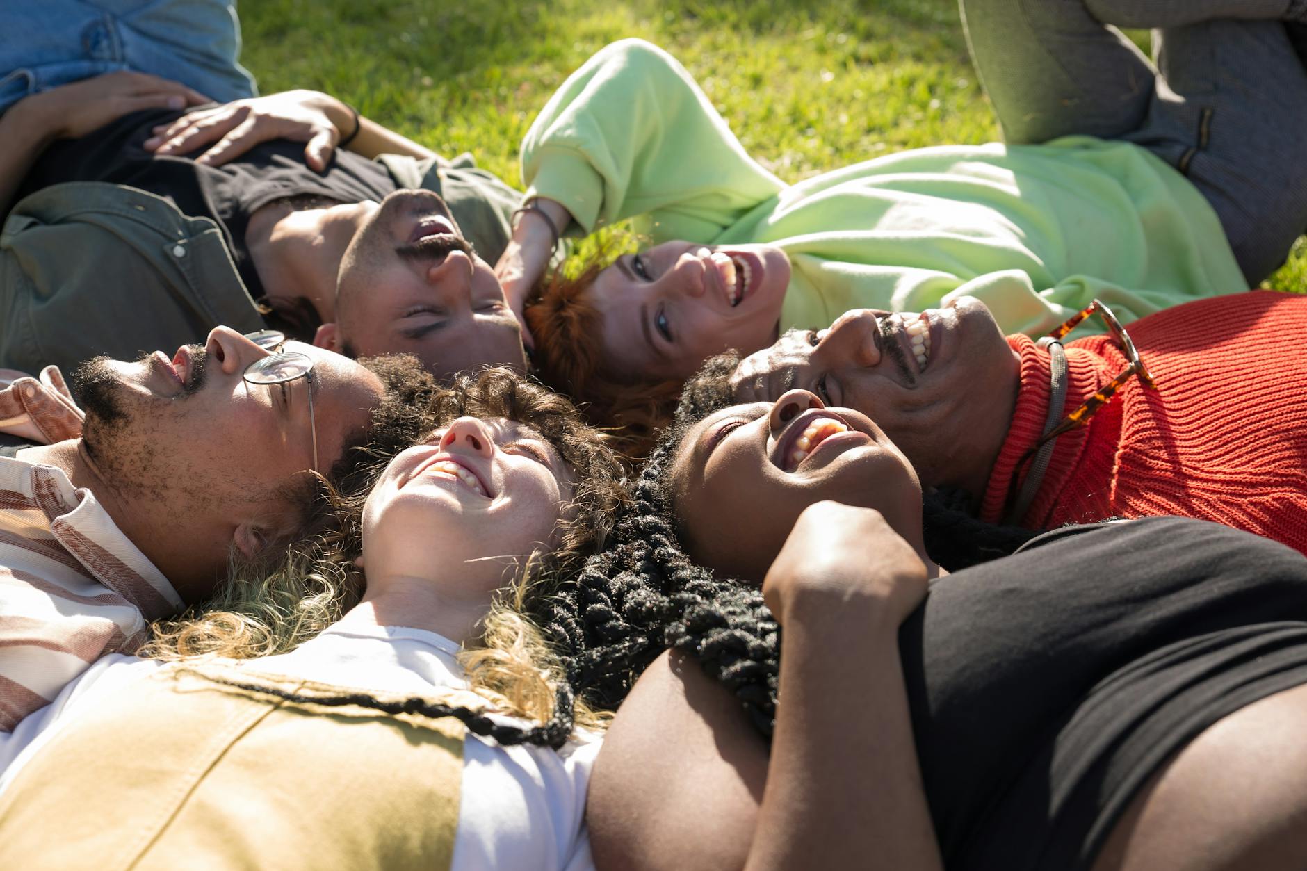 Diverse group of people smiling and relaxing after a yoga class